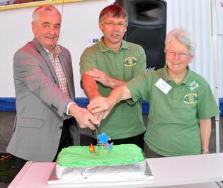 Former Masterton Mayor Bob Francis (left) cuts the cake at the Wairarapa Green Dollar Exchange's 20th anniversary.